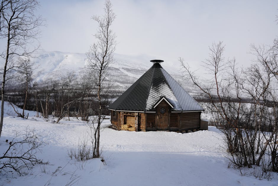 Traditional Scandinavian hut surrounded by snowy landscape in Norrbottens län, Sweden.