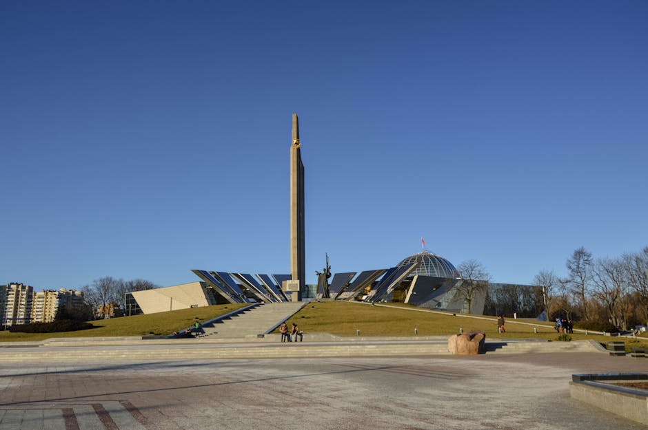 Wide shot of the Victory Monument in Minsk, showcasing its modern architecture under a clear blue sky.
